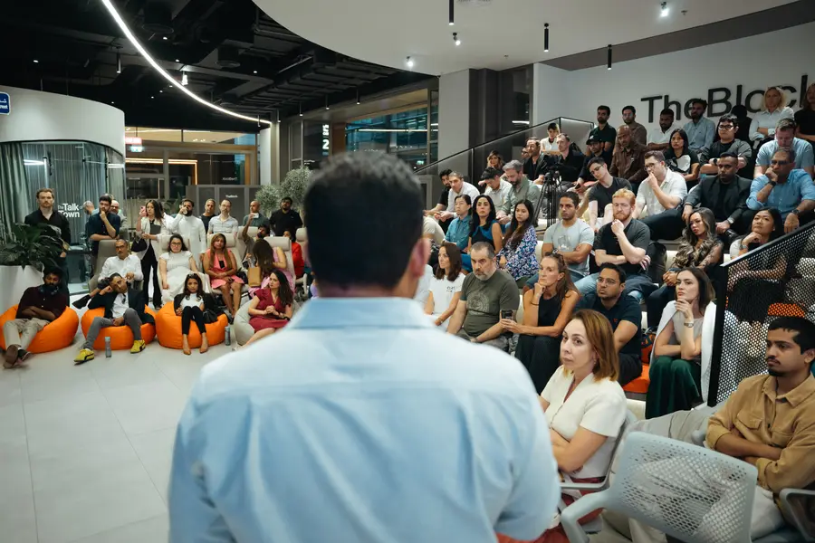 Vishal Sachar addressing a full room, seen from behind the speaker.